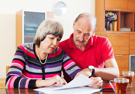 Photo of older couple reviewing paperwork.
